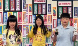 Winners of the 2024 Kids Bookmark Contest holding up their winning entries and trophies